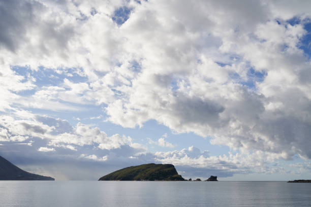 Cloudy sky over green mountains and sea. High quality photo