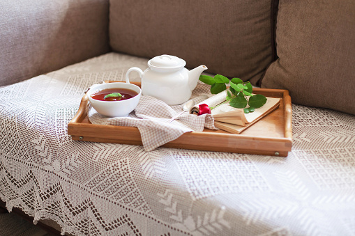 A teapot and tea cups on sofa at home, Tea ceremony concept