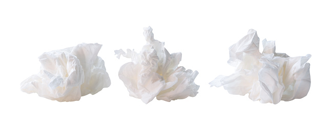 Front view of white screwed or crumpled tissue paper or napkin in set and strange shape after use in toilet or restroom is isolated on white background with clipping path.