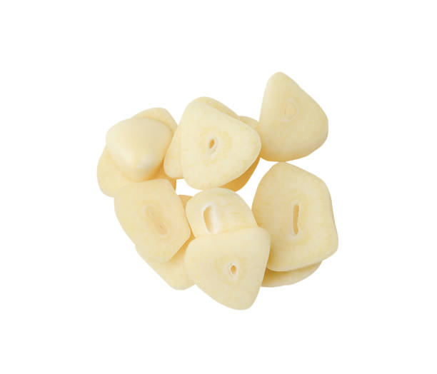 istock Top view of garlic slices or pieces in stack isolated on white background with clipping path 1964201753
