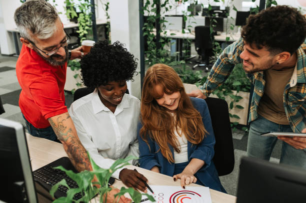 istock A multicultural group of casual executives working on project at firm. 1964203343