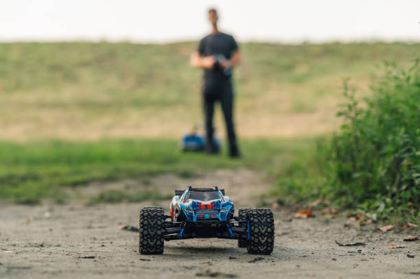 istock Selective focus on a remote control car with man in blurry background. 1964203352