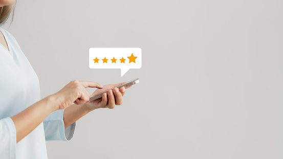 customer satisfaction survey concept businesswoman use smartphone Touch the happy smiley icon. Satisfied. 5 stars. Service experience rating. online application Satisfaction Review best quality.