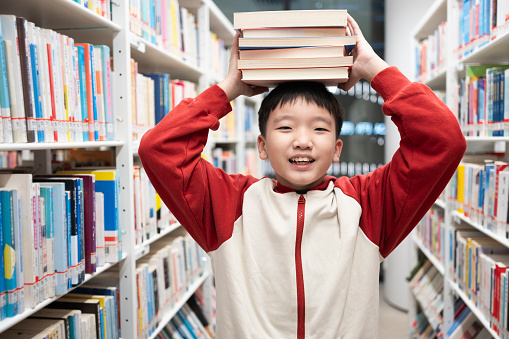 Stack of books opened on library desk