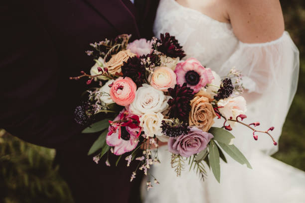 istock Boho wedding gown and purple suit on wedding day 1964260370