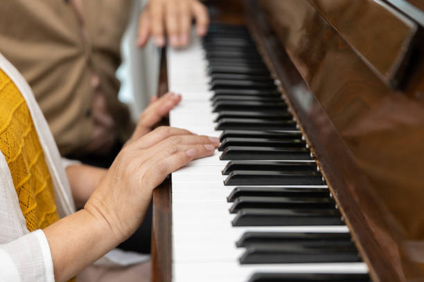 istock closeup elderly hands playing playing classic piano. classical pianist senior learning. 1964317184