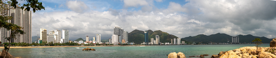 Nha Trang, Vietnam, 26 January 2024: picturesque Nha Trang coastline reveals rocky shore, sunlit beach, and towering modern hotels. coast meets sandy haven, scenic with contemporary architecture