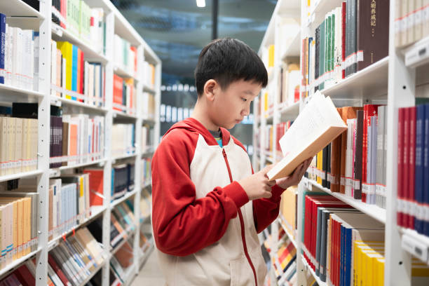 istock Boys to read books in the library 1964323489
