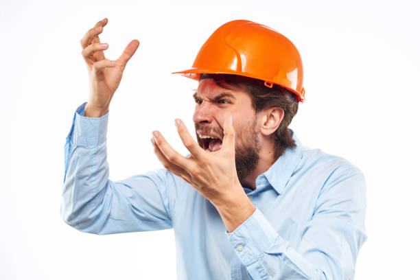 istock Angry man in orange hard hat industry work dissatisfaction cropped view 1964333951