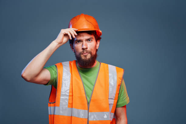 istock Man in working uniform to professionals construction lifestyle blue background 1964341271