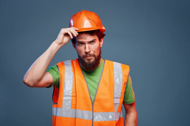 istock Man in working uniform to professionals construction lifestyle blue background 1964344890