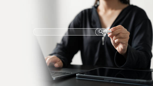istock Woman's hand uses stylus pen to tap search bar for Search Engine, data search, information system, database, internet network, SEO. 1964357953