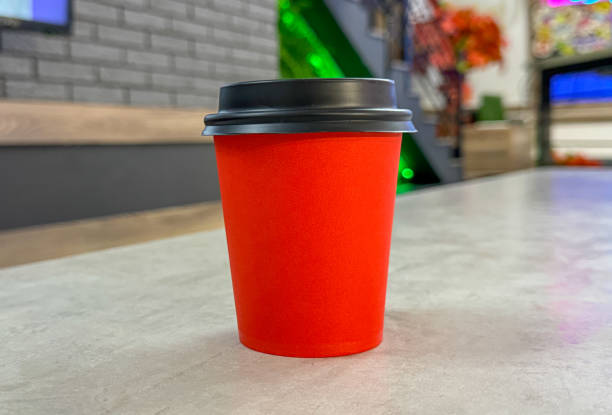 istock Red paper cup for coffee on the table 1964367884