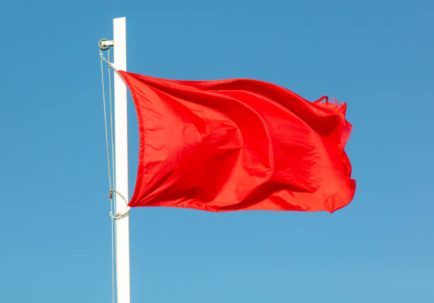 istock Red flag against the blue sky 1964368339
