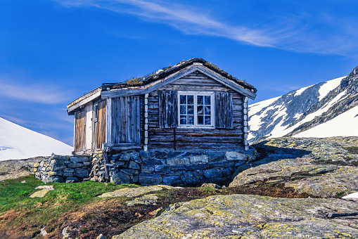 Jotunheimen, Norway-July, 2020: Old wooden cabin on a mountain in sunshine