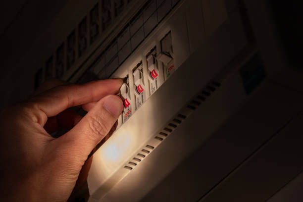 istock Operate the breaker switch on the distribution board in the dark room 1964465111