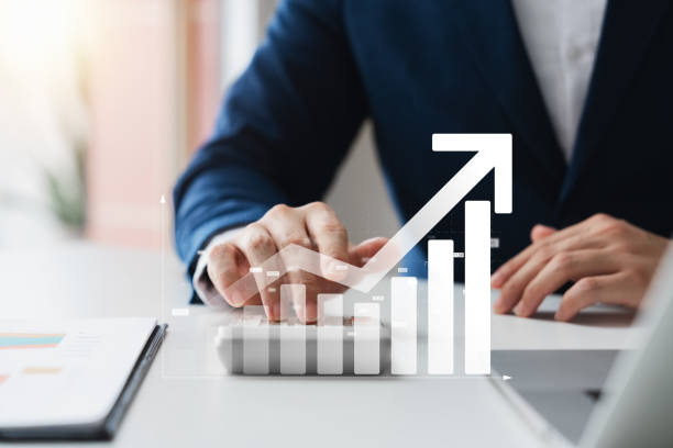 istock Businessman use laptop and tablet analyzing company growth, future business growth arrow graph, development to achieve goals, business outlook, financial data for long term investment. 1964465656