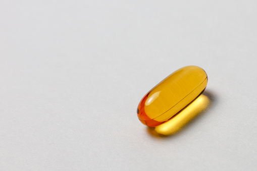 Omega 3 capsule on white background