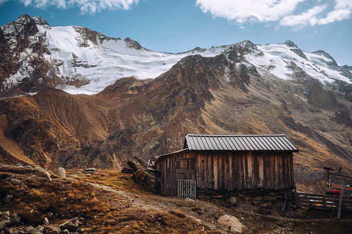 Mountain Supply hut giving shelter near a Church in front of a Glacier