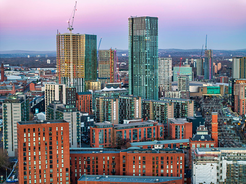 Aerial view of Manchester skyline at dusk showing new urban developments.