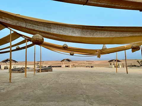 Outdoor patio with vibrant yellow cloths and charming straw umbrellas