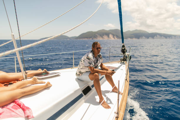 istock Young handsome man enjoying the view on a sailboat 1964708640