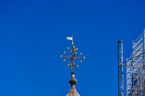 Close up of the gold cross on the top of St Pauls Cathedral, London, UK