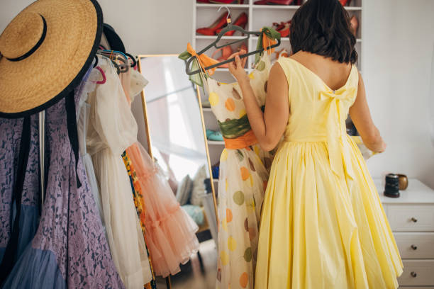 istock Classy woman choosing dress for today 1964709330