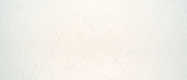 This image showcases a close-up view of a textured white surface with a web of fine scratches and nuanced variations in tone.