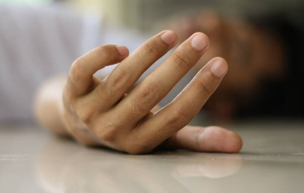 istock a man collapsed on the floor,focus on Hands, tired or sick concept. 1964751190