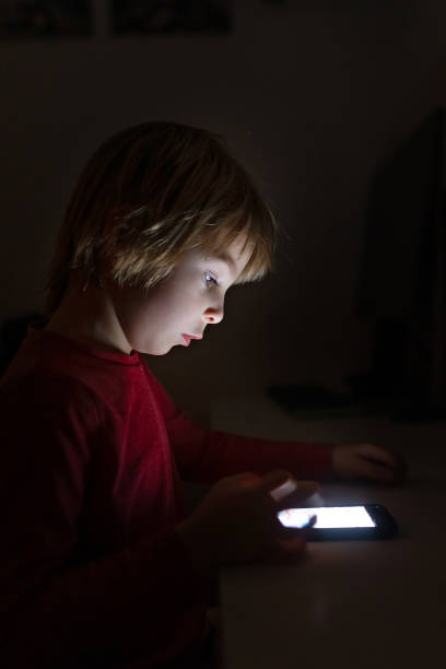 istock Cute child, boy, playing on mobile phone 1964777504