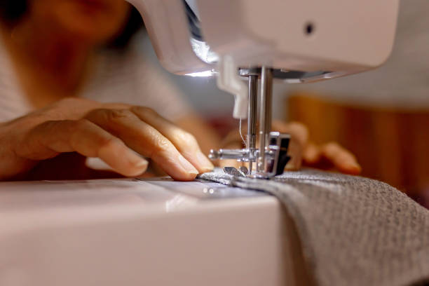 istock Woman, sewing small pillows on a sewing machine 1964778038