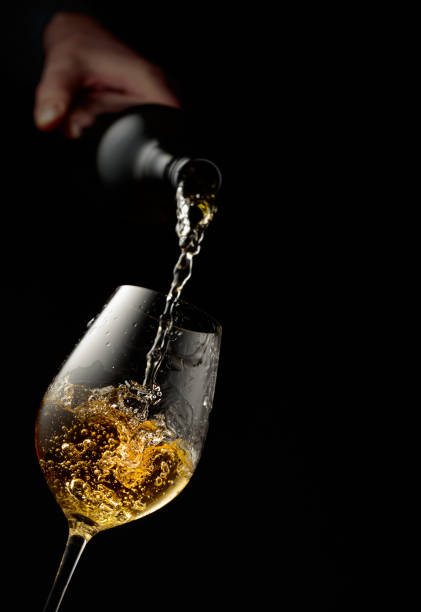 istock Pouring white wine into a glass. 1964782277