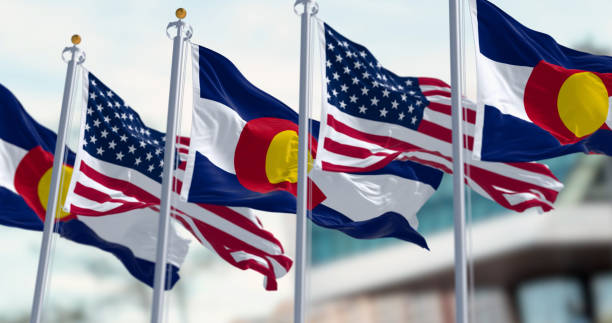 istock Colorado and US flags waving in the wind on a clear day 1964784487