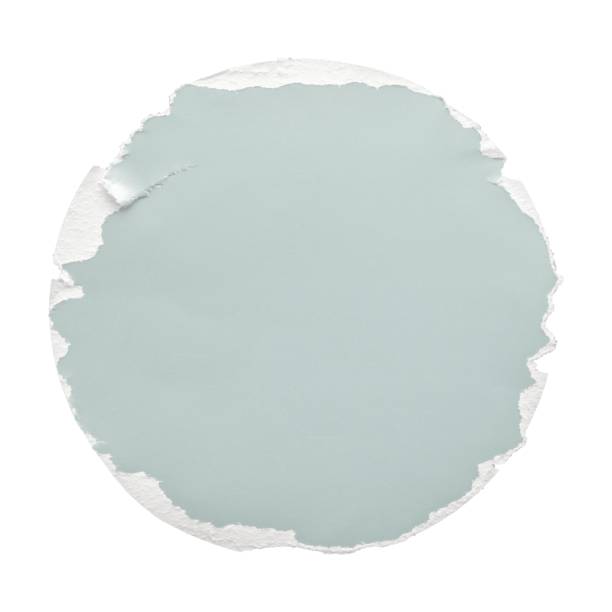 A teal round sheet of paper with roughly torn edges