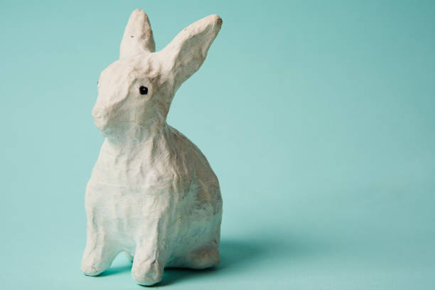 istock Festive white rabbit toy on a blue background with pastel colors Easter 1964792610