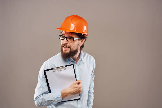 istock A man in orange paint with documents in hands building an industrial business 1964810141