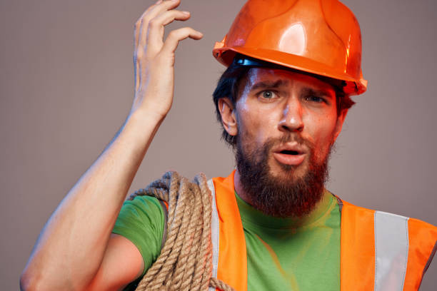 istock man in construction uniform orange hard hat construction cropped view 1964817229
