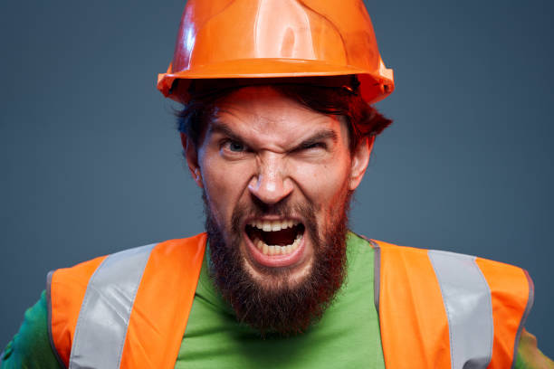 istock Angry worker in construction forum emotions cropped view autumn background 1964822557