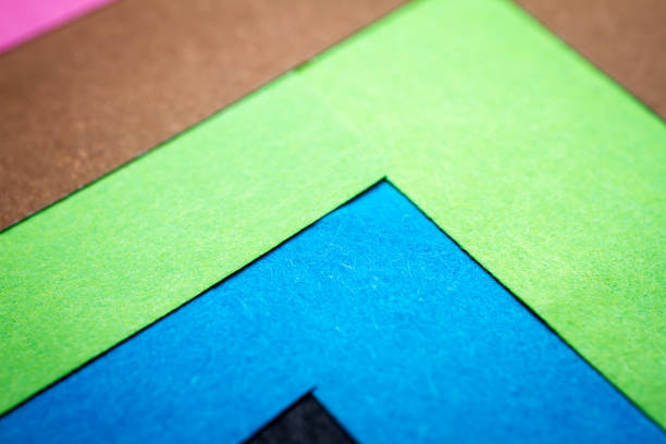 Papers of various colors are placed on top of each other creating an abstract sequence