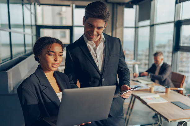 istock Business people discussing daily plans in the office using laptop. Teamwork situation concept 1964922184