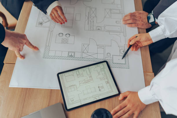 istock Close up of professional team design engineers working with project documents in modern office 1964924899