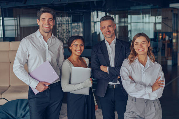 istock Group of diverse business people standing on office background and looking on camera 1964928083