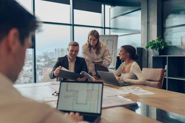 istock Coworkers discussing biz related problem in the office and using laptop. Conception of business team 1964930217