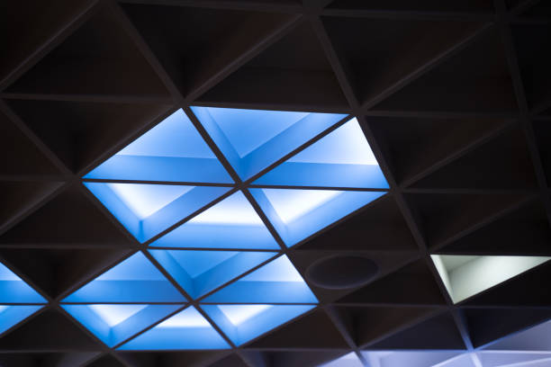 istock The illuminated ceiling of a modern design hotel seminar room has a geometric triangle shape 1964932844