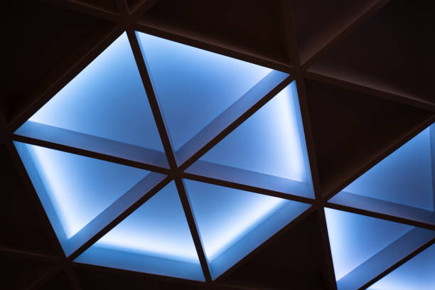 istock The illuminated ceiling of a modern design hotel seminar room has a geometric triangle shape 1964932845