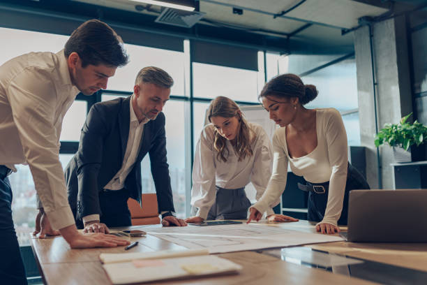 istock Group of professional business managers working with project documents in office 1964948366
