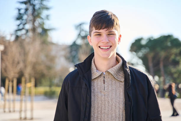 istock Successful student at university campus, education concept. Smiling man with perfect teeth posing outdoors. 1964948549
