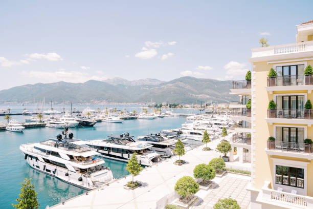 Expensive motor yachts are moored along the shore near the Regent Hotel. Porto, Montenegro Expensive motor yachts are moored along the shore near the Regent Hotel. Porto, Montenegro. High quality photo montenegro stock pictures, royalty-free photos & images