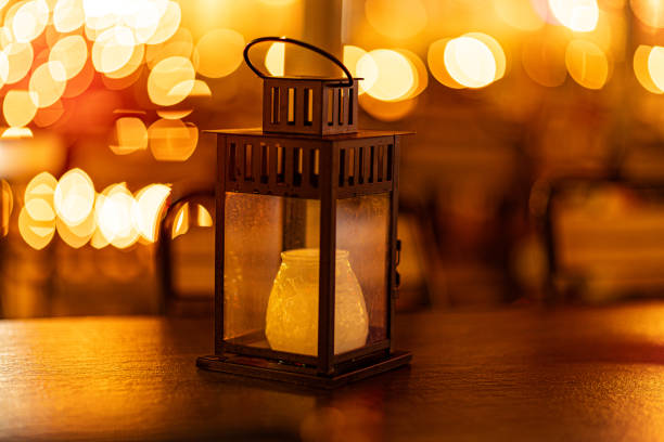 A lantern placed in front of the sparkling bokeh lights